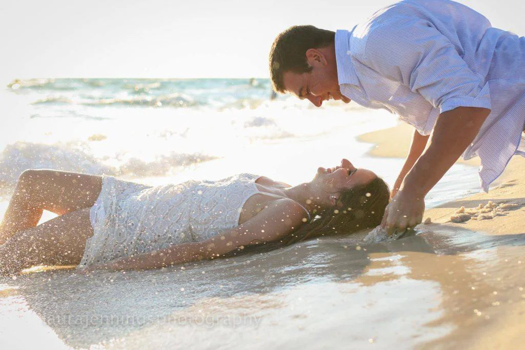 A romantic image of an engaged couple interacting with each other at the waters edge