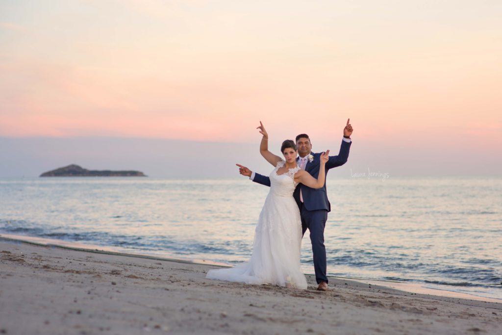 Husband and wife eloped in Panama City Beach, standing on the shoreline