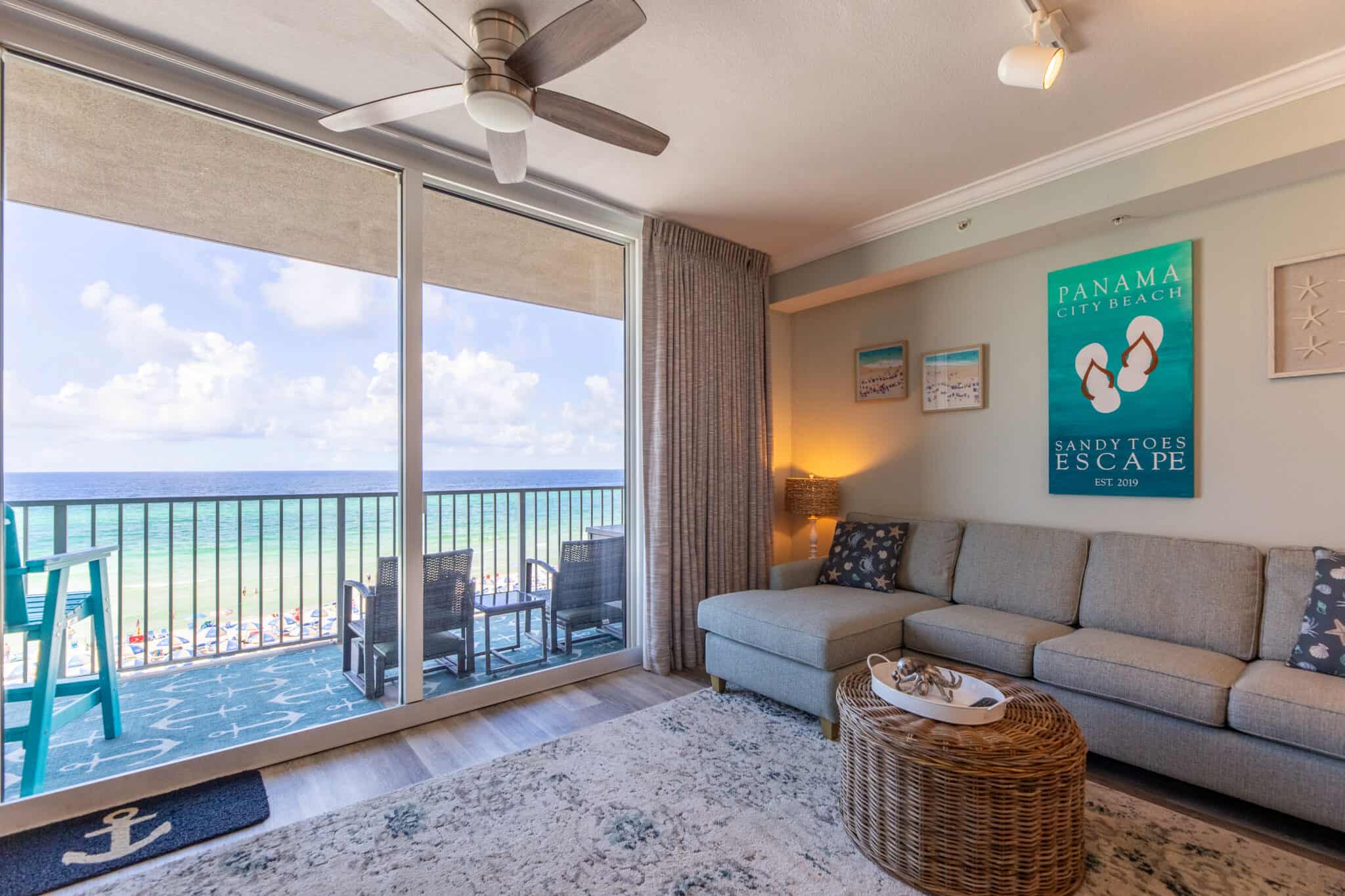 Living space overlooking the beach with ceiling to floor glass windows