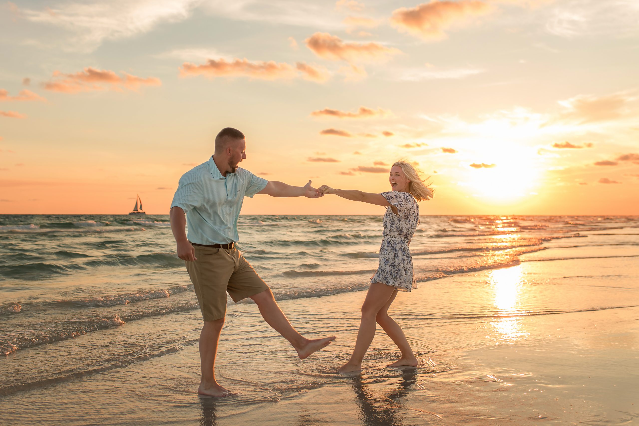 An engaged couple having a sunset photo session at Panama City Beach
