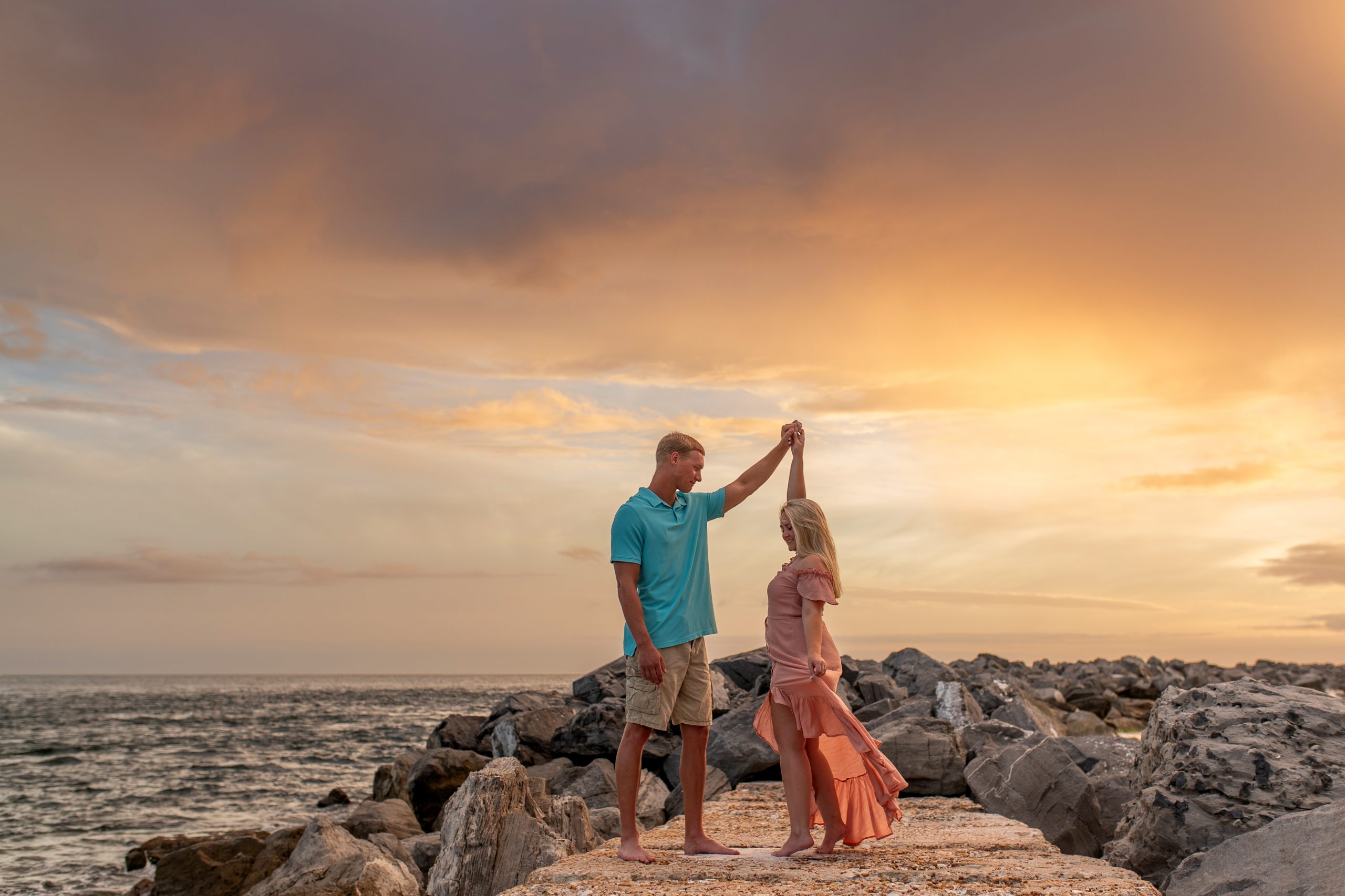 A couple dancing on the rocky shore of Panama City Beach
