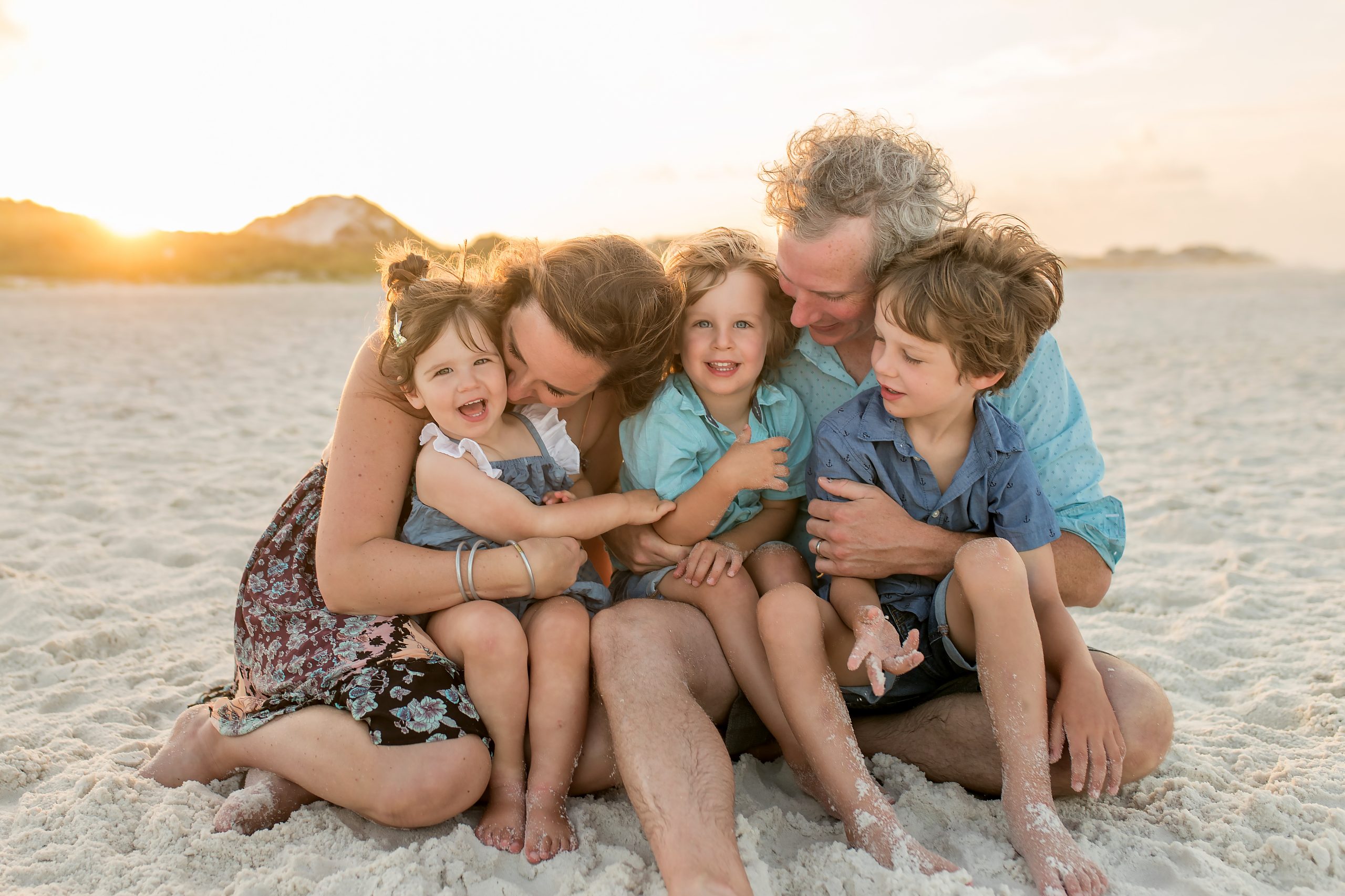 A family having a sunset photo session with Laura at Panama City Beach